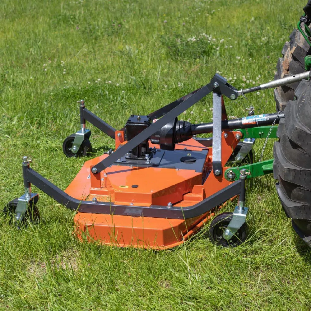 Right-angle gearbox on a lawn mower showing the PTO input connection and blade output shaft