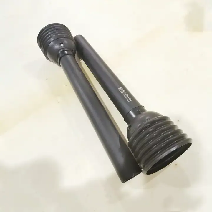 PTO shaft with safety shield properly installed showing full protective coverage over the rotating shaft and universal joints